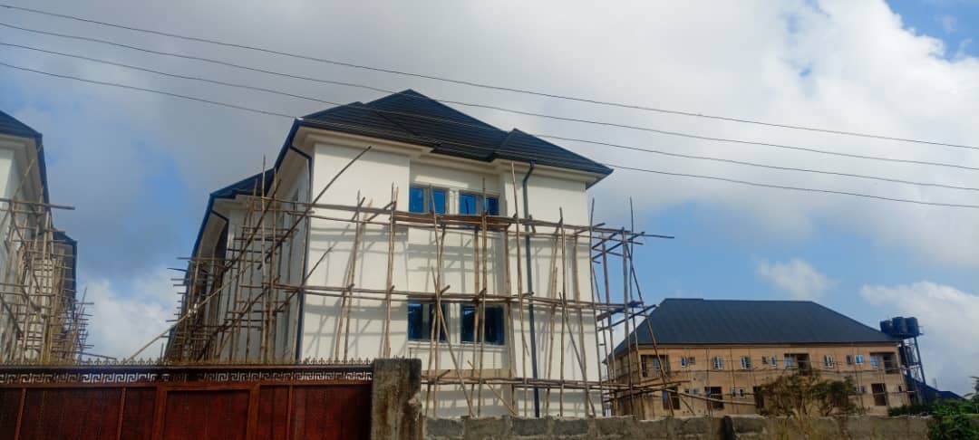 Building exterior with roofing and scaffolding at a construction site